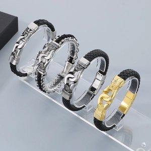 Detailed macro of 316L stainless steel clasps with punk totem engraving on leather bracelets