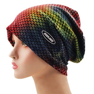 Close-up of rainbow gradient knitted beanie with honeycomb breathable texture and logo