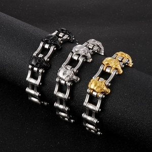Three men's skull link bracelets in gold, silver and black finish on dark background