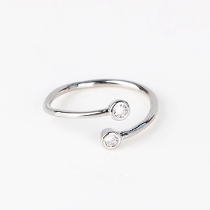Detail of silver adjustable open ring featuring two sparkling round cubic zirconia stones