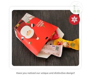 Macro view of Christmas candy box with Santa graphics on dark wood background
