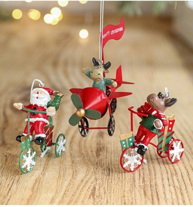 Three creative metal Christmas ornaments featuring Santa and reindeer on tricycle and plane