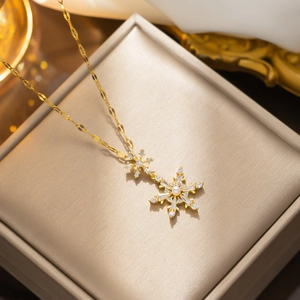 Golden titanium steel necklace with diamond-encrusted snowflake and pearl pendant in box