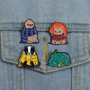 Set of four cartoon animal enamel pins featuring school house eagle, lion, badger and snake