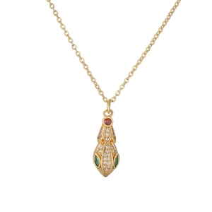 Detailed view of gold plated necklace featuring a snake pendant with red and green zircons