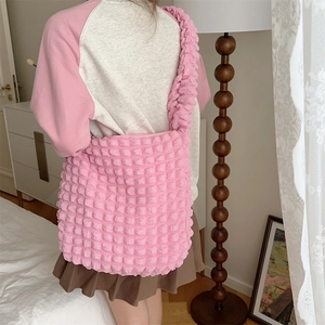 Pink bubble texture large capacity tote bag shown on model in a soft minimalist room