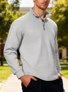 Detail of light grey waffle knit fabric and quarter-zip collar on men's pullover