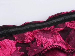Close-up of pink lace fabric with black non-slip silicone strips on the inner edge