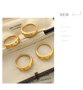 Detailed macro view of 18K gold plated star pattern rings with inlaid cubic zirconia