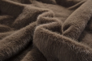 Close-up of deep brown faux fur fabric showing soft plush texture and thick fibers