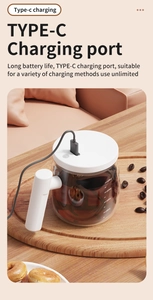 Detail of clear glass self-stirring mug showing Type-C charging port in cozy home setting