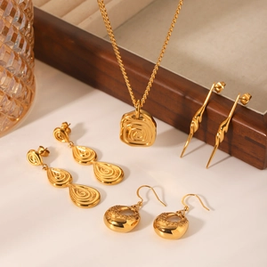 Golden stainless steel jewelry set featuring embossed pendant necklace and stylish earrings