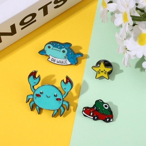 Cartoon enamel pin set featuring whale, crab, star, and frog icons for backpack decor