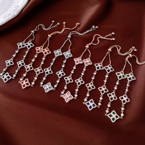Detail view of adjustable zircon flower bracelets in six colors on brown satin fabric