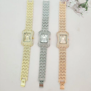 Detailed view of three luxury square watches in gold, silver and rose gold with rhinestones