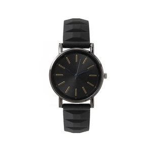 Minimalist black and gold quartz watch with a textured silicone strap for women
