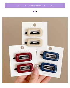 Detail of colorful geometric resin hair clips set in beige, burgundy, and navy blue