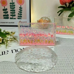 Close-up of DIY tulip night light with pink flowers and gold glitter in acrylic box