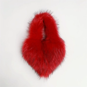 Macro detail of red faux fur heart-shaped bag with black tips and plush texture