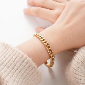 Minimalist gold Cuban link chain bracelet shown on wrist for a classic professional look