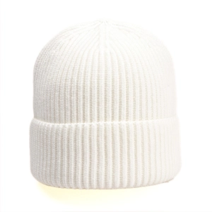 Detailed close-up of white ribbed knit beanie featuring thick vertical texture and folded cuff