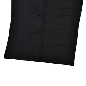 Close-up of black bodycon dress detailing the vertical seam and breathable synthetic fabric