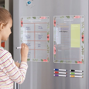 Action shot of girl writing on magnetic acrylic weekly planner with floral patterns