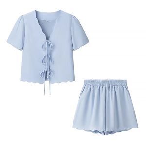 Detail of light blue two-piece set with tie-front bow tops and scalloped hem edges
