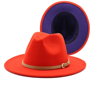 Detail of red and purple two-tone wool fedora hat with faux leather belt buckle strap