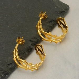 Polished gold hollowed-out branch hoop earrings with intricate layered vine line design