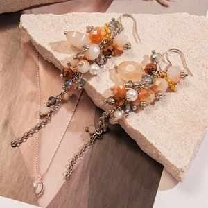 Vintage bohemian beaded tassel earrings with amber glass beads and pearl accents