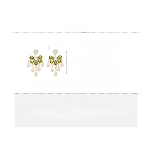 Detail view of olive green zircon drop earrings with size and weight dimensions