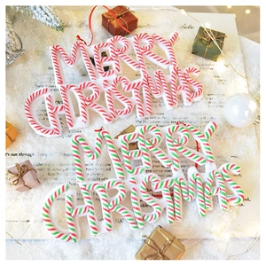Macro detail of Merry Christmas sign ornament with candy cane texture on faux snow