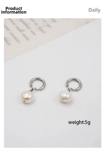 Detail of silver drop earrings with white freshwater pearl and rhinestone accents
