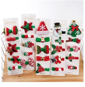 Detailed set of Christmas hair clips featuring snowmen, trees and festive bows on cards