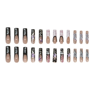 Long square press-on nails with black bows, zebra stripes, and star patterns
