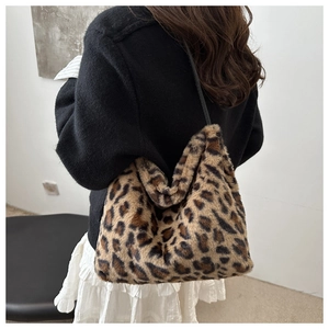 Detail of soft leopard print faux fur texture and slouchy design of the shoulder tote bag