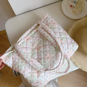 Macro detail of quilted floral cotton tote bag with soft diamond stitching pattern