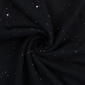 Detail of black mesh evening dress fabric with shimmering silver glitter and sequins