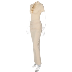 Detailed view of apricot ruched dress with deep V-neck and short sleeves on mannequin