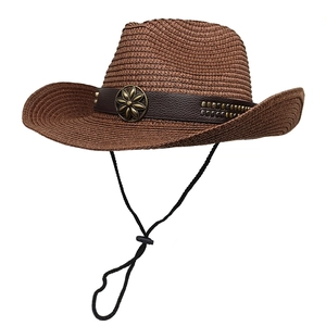 Detail of a brown woven western cowboy hat with vintage metal flower and adjustable chin strap