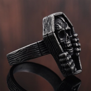Detailed view of Gothic coffin ring with skull engraving and realistic wood grain texture