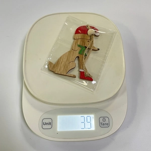 Detailed view of a rustic wooden dog ornament with Christmas hat weighing 3.9g