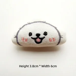 Close-up of white plush dumpling accessory with facial embroidery and 3.8cm height