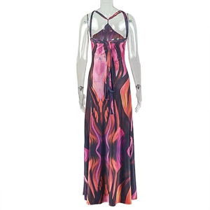 Close-up of vibrant abstract print maxi dress featuring open back with waist tie details