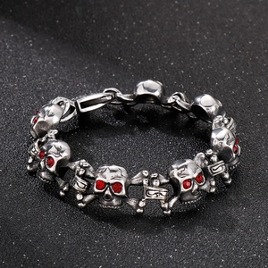 Macro shot of stainless steel hip hop bracelet with red zircon eye skull beads
