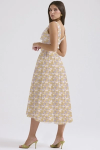 Detail of cross cut-out back design on light yellow floral print summer maxi dress