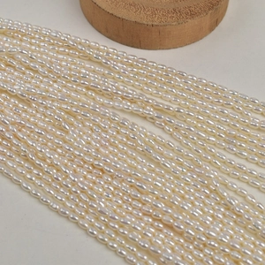 Detailed view of small oval freshwater pearls with natural white luster for DIY jewelry