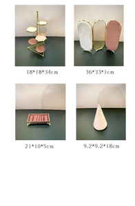 Detailed views of gold metal jewelry stands with pink and white velvet lining