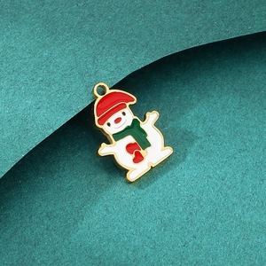 Detailed view of an enamel snowman charm with red hat and green scarf for DIY jewelry